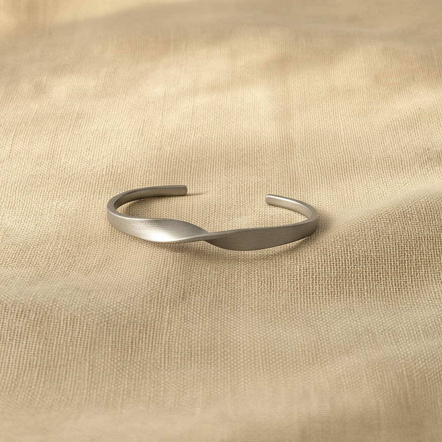 Silver bracelet on a beige fabric background