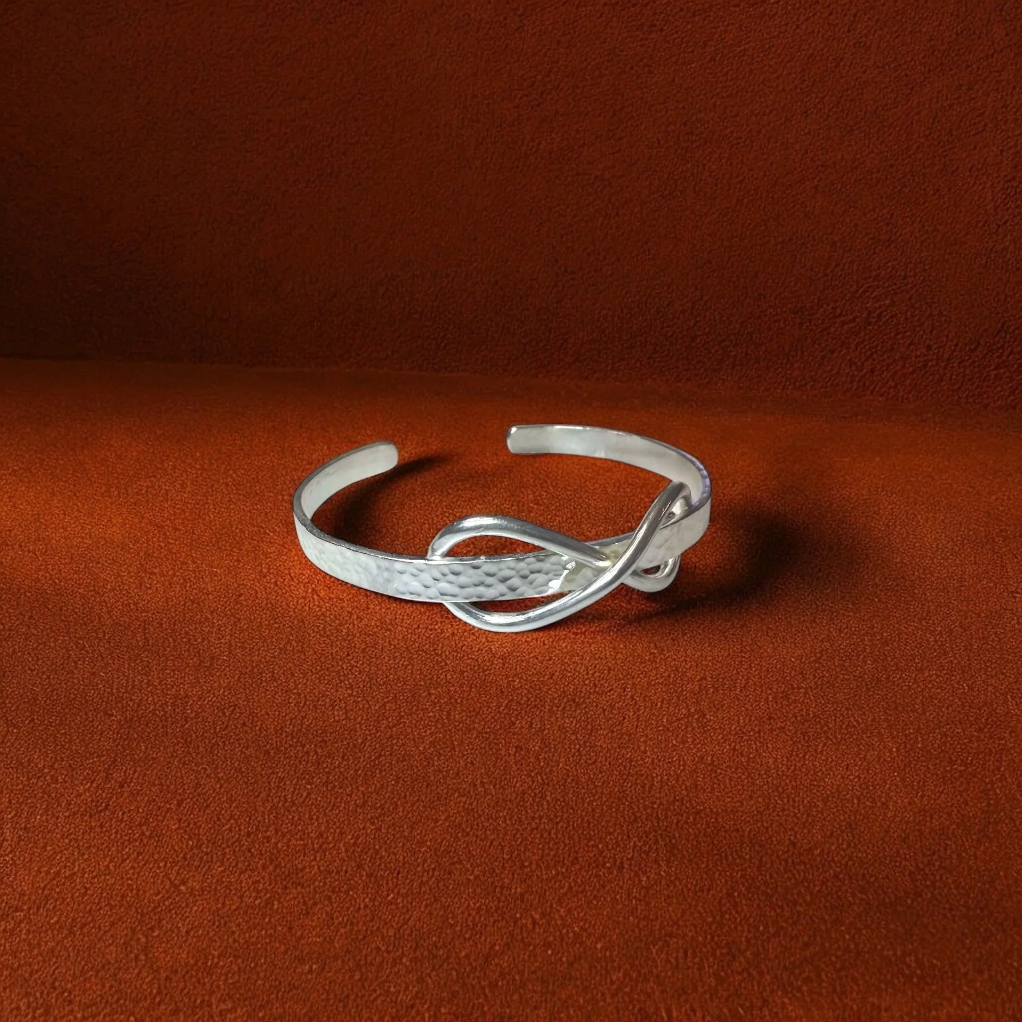 Silver bracelet on a brown background