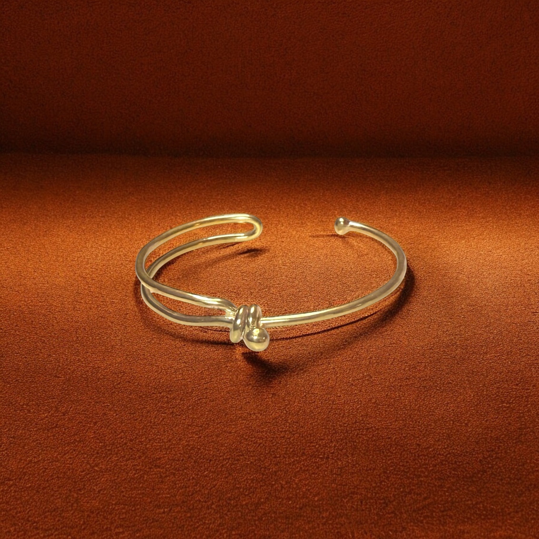 Gold bracelet on a brown background