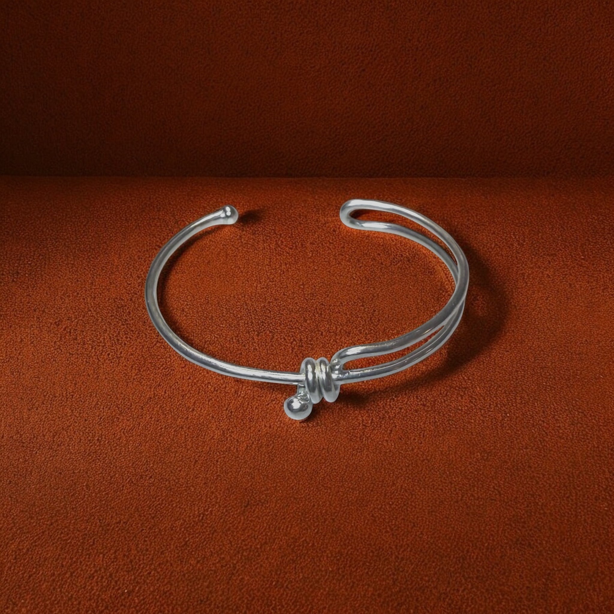 Silver bracelet on a brown background