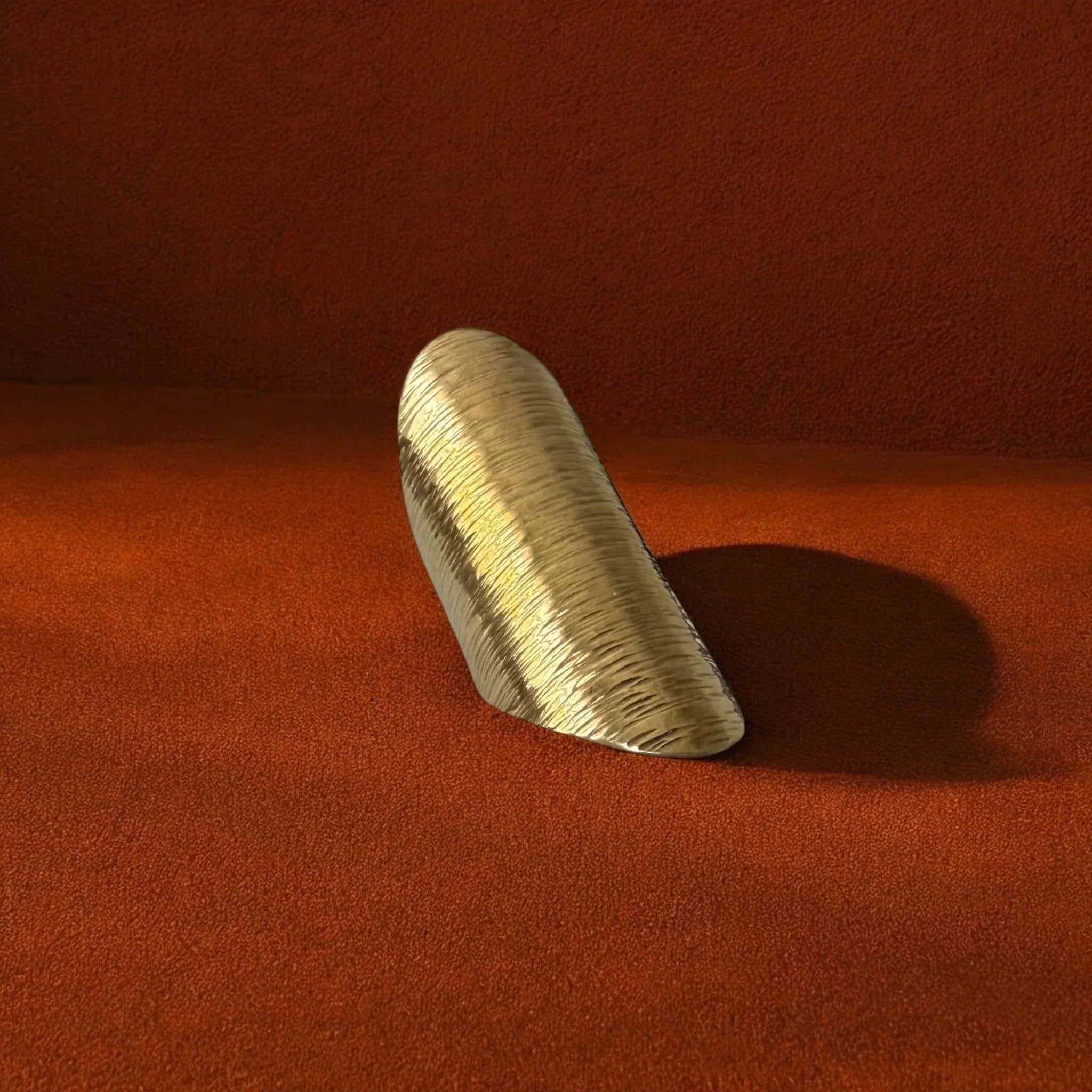 Wooden object on a textured red surface