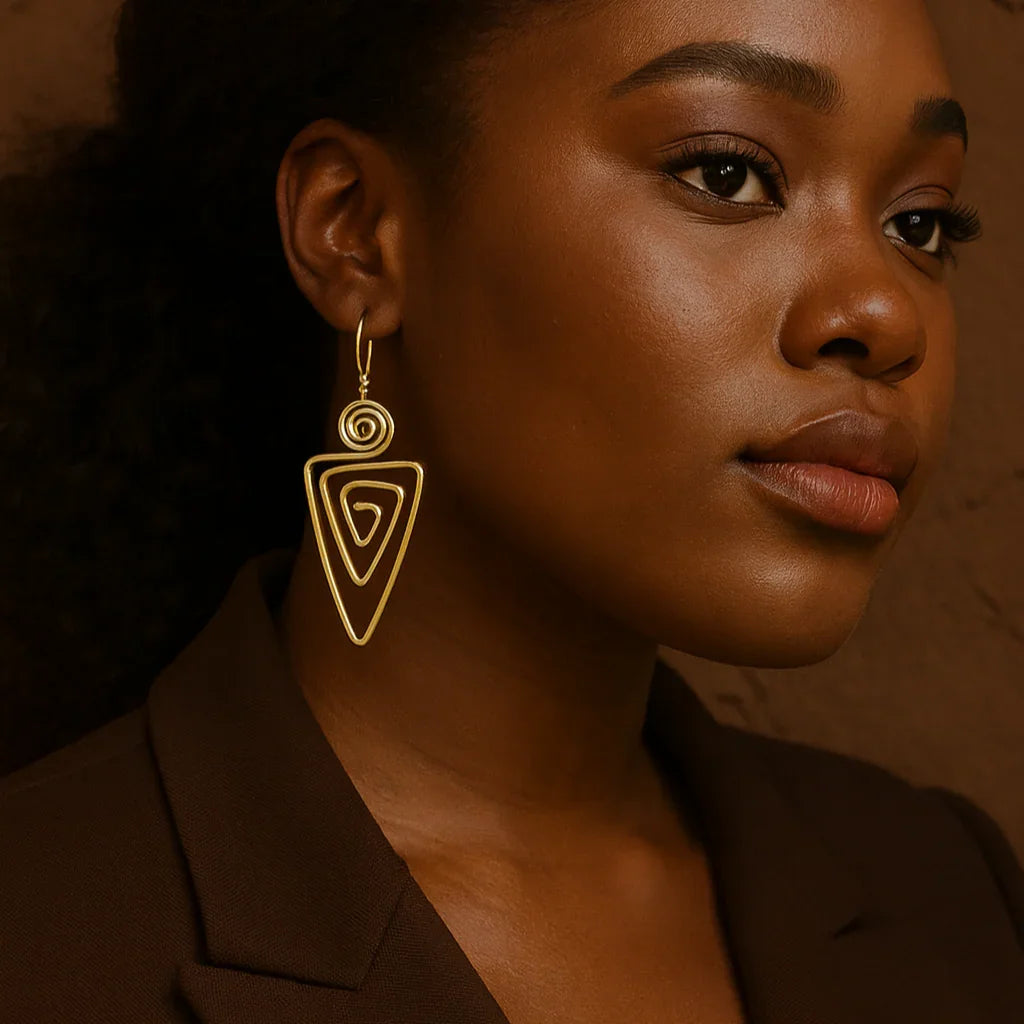 Woman wearing gold earrings against a brown background