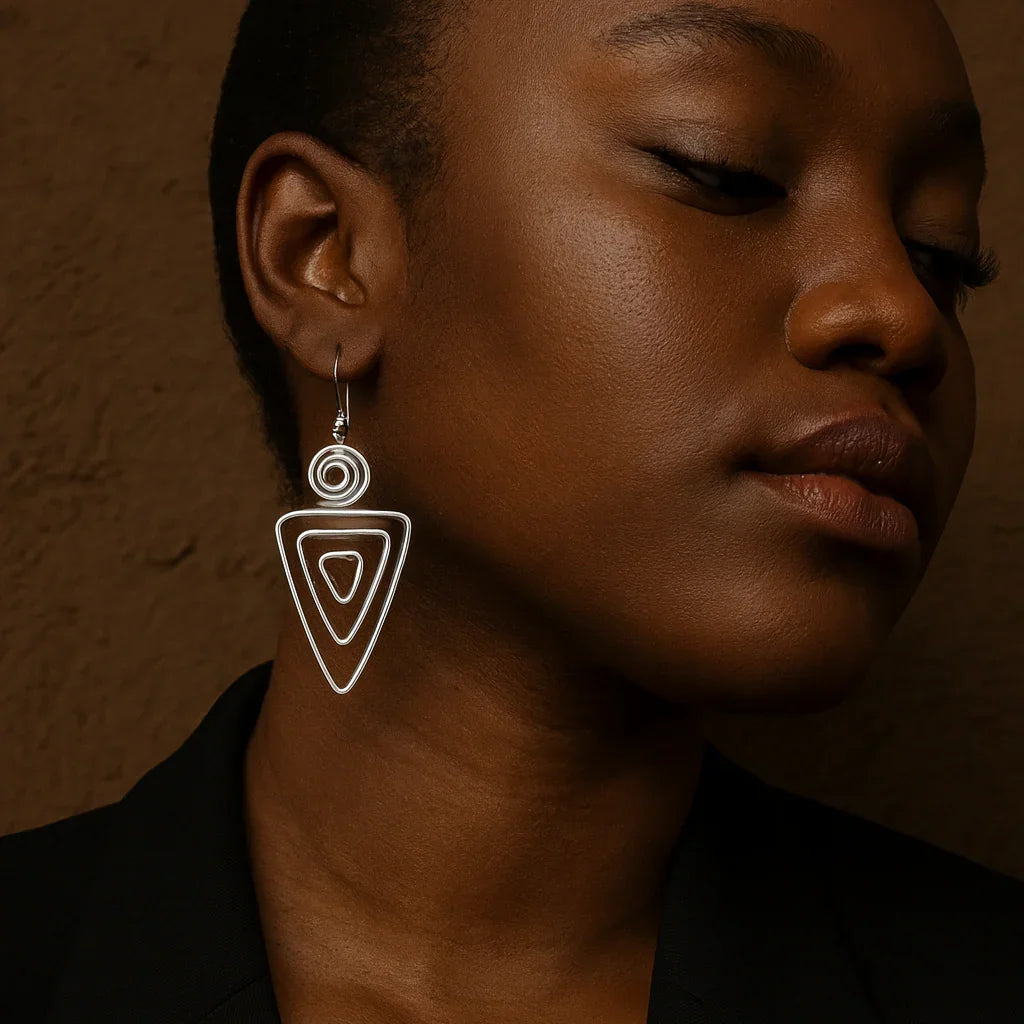 Woman wearing a unique earring against a brown background