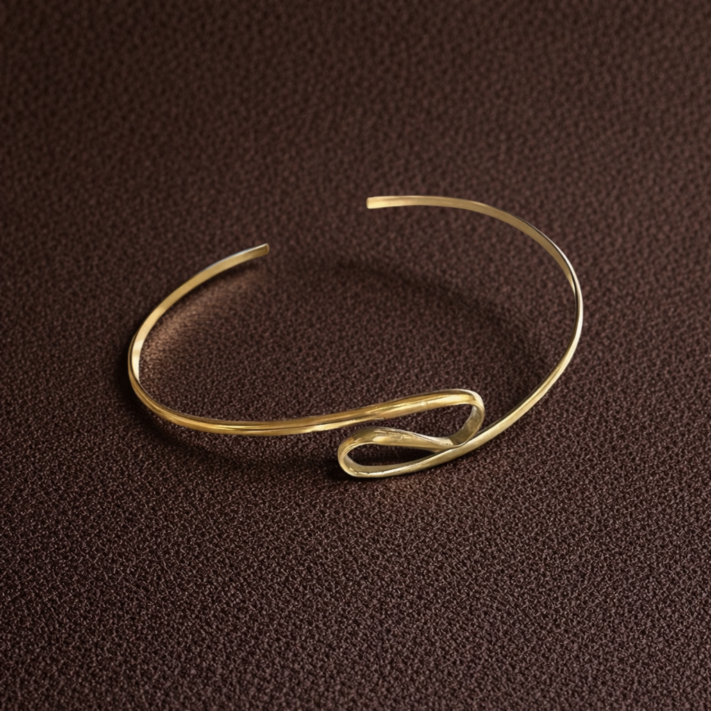 Gold bracelet on a brown textured background