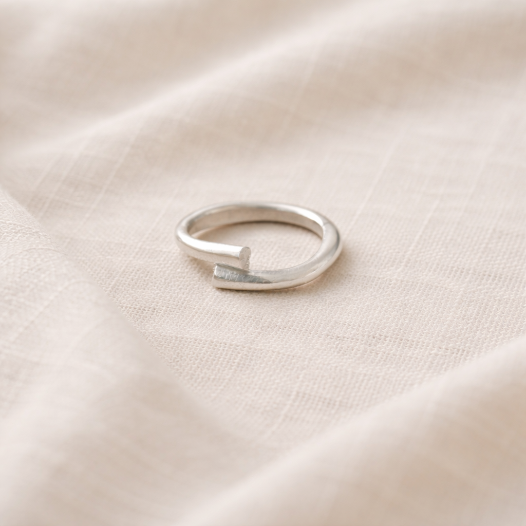 Silver ring on a beige fabric background