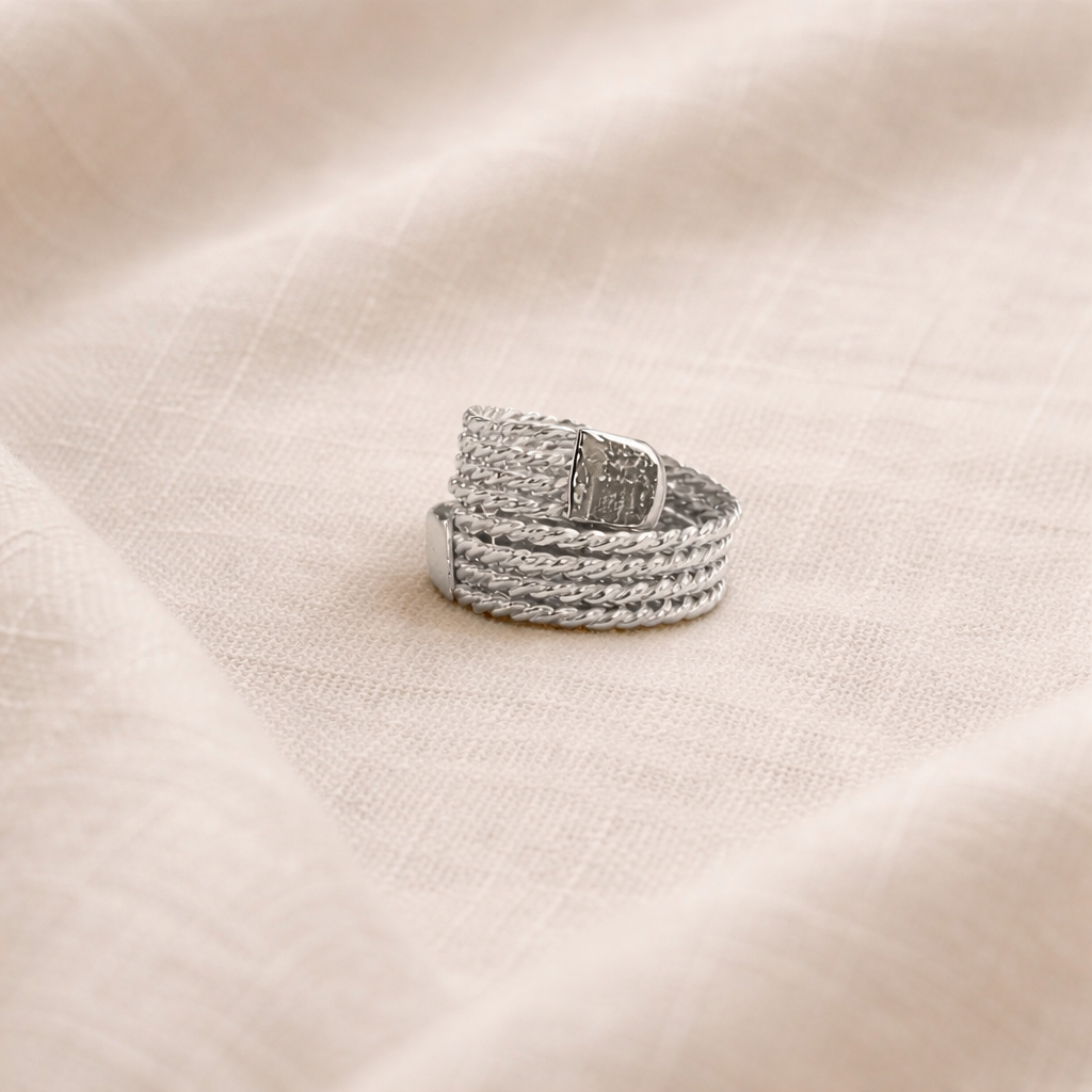 Silver ring on a beige fabric background