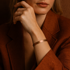 Woman wearing a rust-colored coat against a matching background