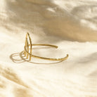 Gold bracelet on a beige fabric background