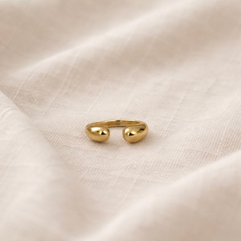 Gold ring on a textured beige fabric background