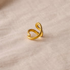 Gold ring on a beige fabric background