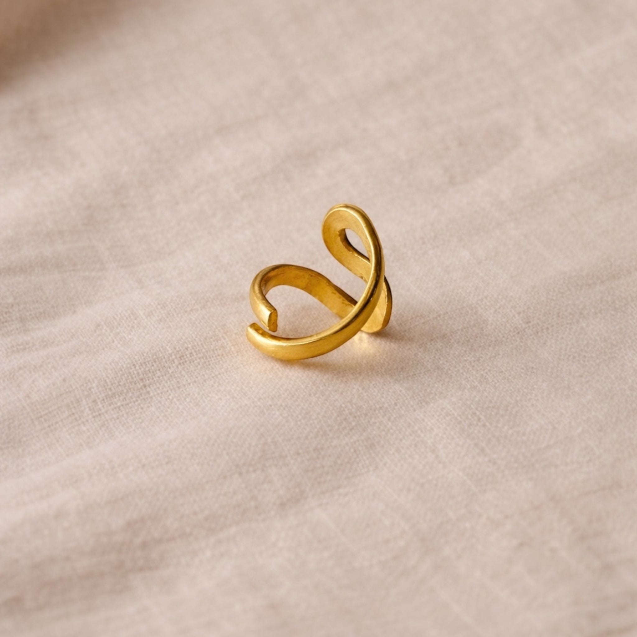 Gold ring on a beige fabric background