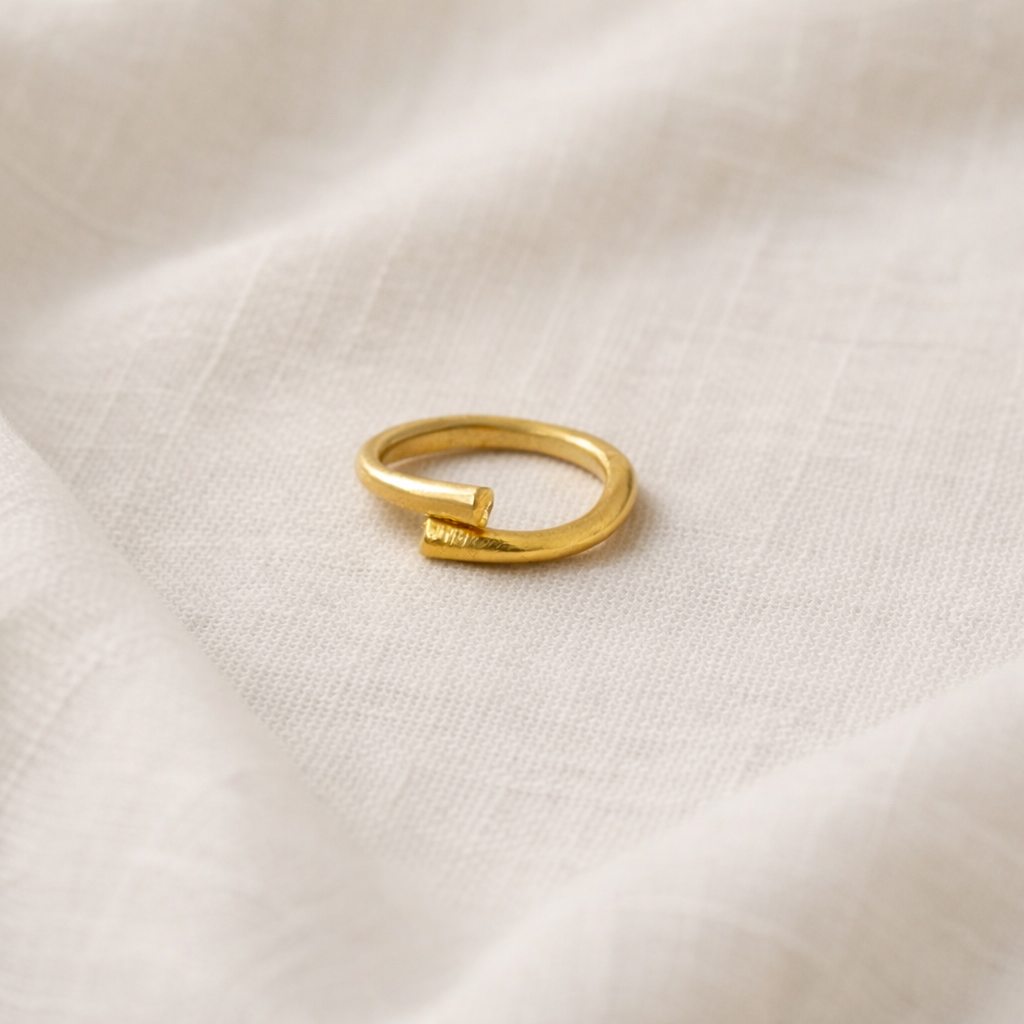 Gold ring on a textured beige fabric background