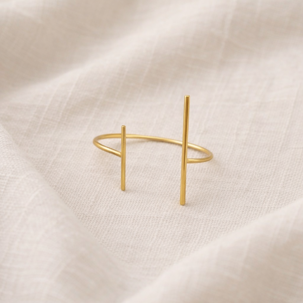 Gold bracelet on a beige fabric background