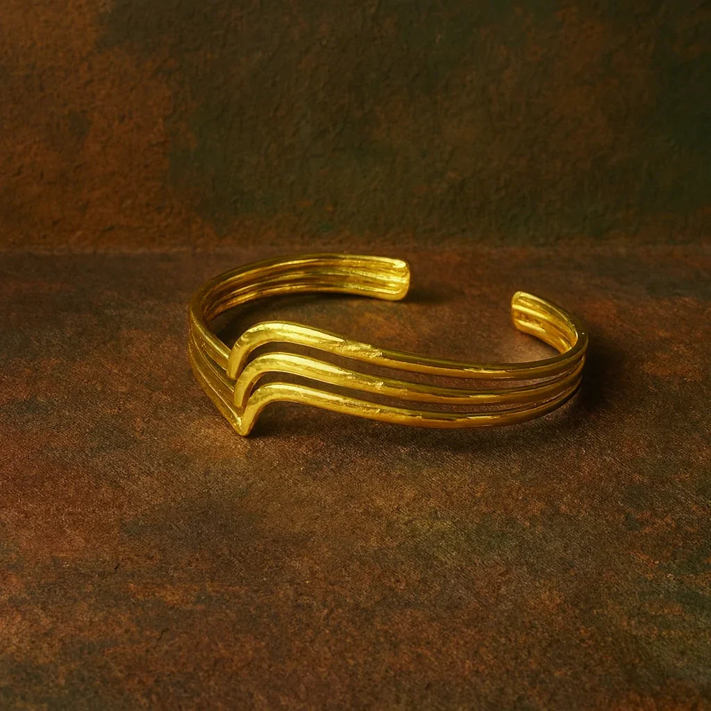 Gold bracelet on a textured brown surface
